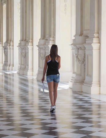 VENARIA, ITALY - CIRCA AUGUST 2018: Young woman in Galleria Grande aka Galleria di Diana (meaning Great Gallery or Diana Gallery) at Reggia di Venariaのeditorial素材
