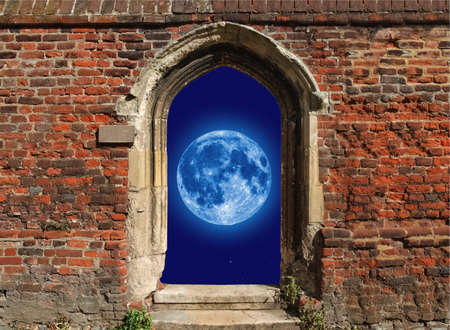 Full moon seen through an old gothic window in red brick wallのeditorial素材