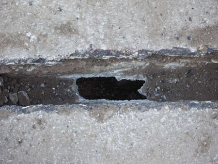 damaged water pipe during road excavation works at construction site for laying of fibre optic cable in FTTH (Fibre to the home) modeの写真素材