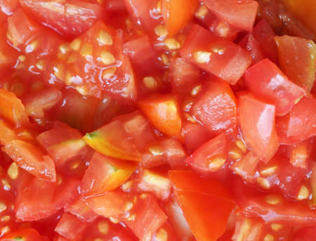 chopped tomato preparation for pizza vegetarian foodの写真素材