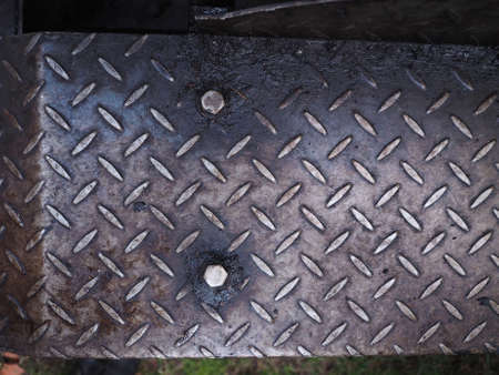 Grunge industrial diamond steel plate metal texture useful as a background