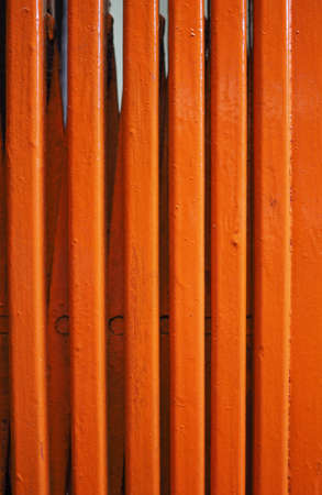 old steel metal shutter painted in orangeの写真素材