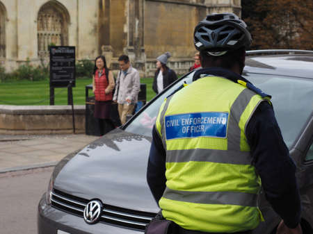 CAMBRIDGE, UK - CIRCA OCTOBER 2018: civil enforcement officer at work