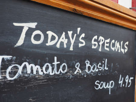 Restaurant blackboard with today's special tomato and basil soupの写真素材