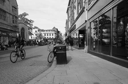 CAMBRIDGE, UK - CIRCA OCTOBER 2018: People in the city centre in black and white