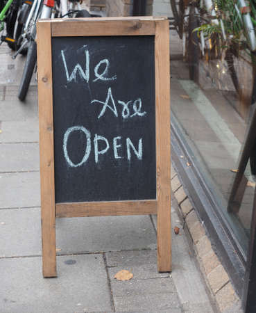 we are open sign on a blackboard