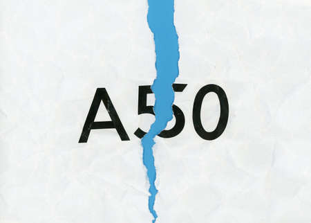 Torn paper with word A50 representing the growing request to revoke Article 50 to stop Brexit and...