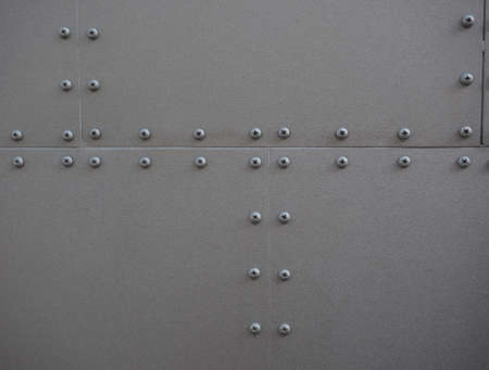 grey steel metal texture with screws useful as a backgroundの写真素材