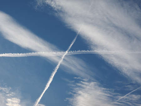blue sky with plane vapour trails (aka contrails, short for condensation trails)の写真素材