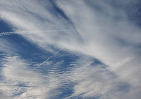 blue sky with plane vapour trails (aka contrails, short for condensation trails)