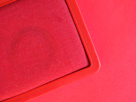 a stamp pad filled with red ink