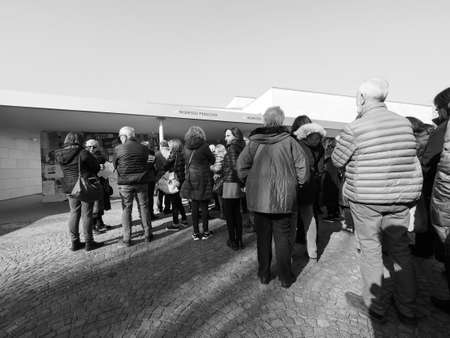ALBA, ITALY - CIRCA FEBRUARY 2019: People queueing to visit an exhibition at Fondazione Ferrero art gallery in black and whiteのeditorial素材