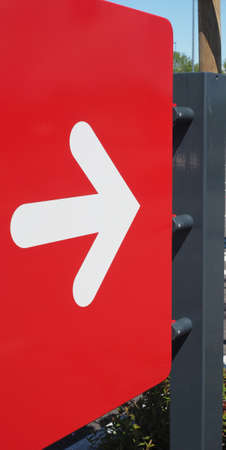right direction arrow sign in white over red backgroundの写真素材