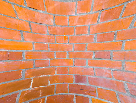 curved red brick wall texture useful as a backgroundの写真素材