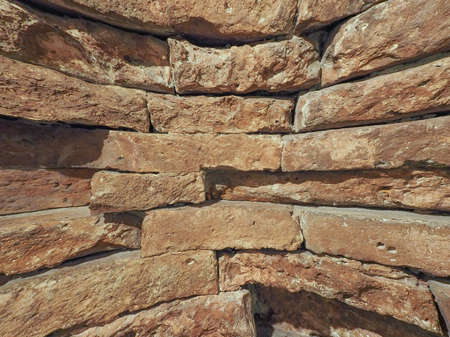 curved red brick wall texture useful as a backgroundの写真素材