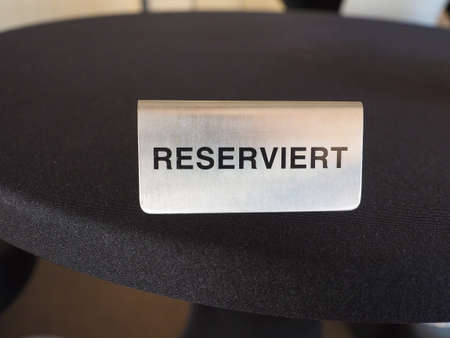 Reserviert (meaning Reserved in German) sign on a restaurant tableの写真素材