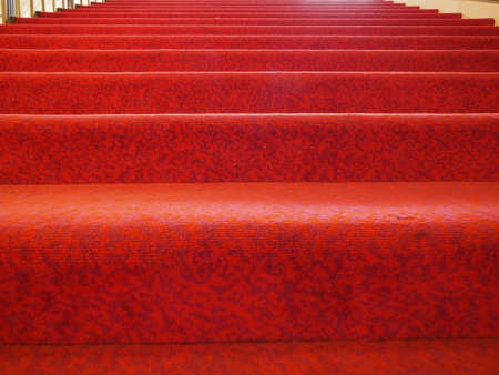 stairs with red carpet fabric useful as a backgroundの写真素材