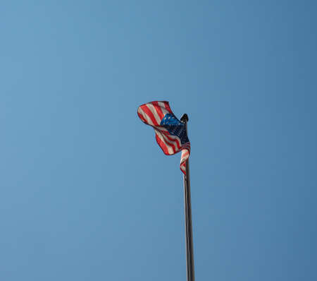 the American national flag of United States of America over blue skyの写真素材
