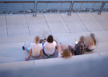 unrecognisable young people on Rheinboulevard riverside walkway with steps overlooking the river Rhineの写真素材