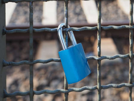 Love lock padlock locked to a bridge fenceの写真素材
