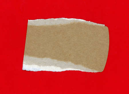 brown cardboard over a red paper backgroundの写真素材