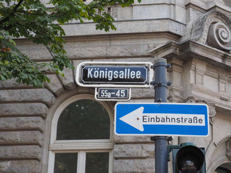 Koeningsallee (meaning King's Avenue) and Einbahnstrasse (meaning One Way street) signs in Duesseldorf, Germanyの写真素材