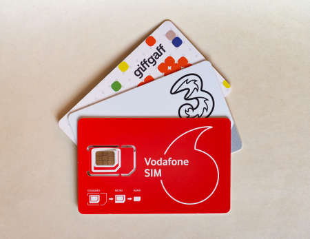 LONDON, UK - CIRCA OCTOBER 2019: Vodafone, Three and Giffgaff mini micro and nano sim cards for...