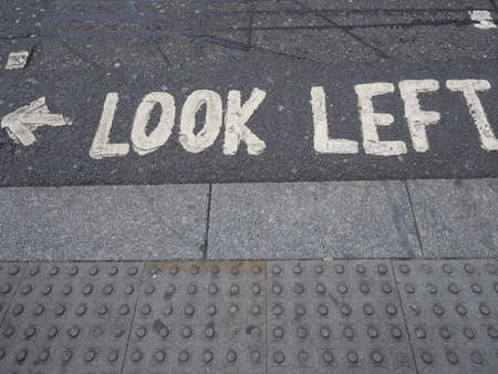 Look Left traffic sign on a London street tarmacの写真素材