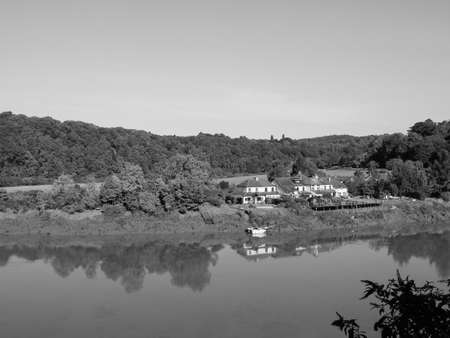 River Wye (Afon Gwy in Welsh) marks the border between England and Wales in Chepstow, UK in black...