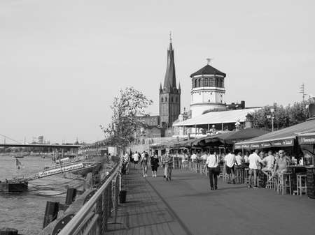 DUESSELDORF, GERMANY - CIRCA AUGUST 2019: People on Rheinuferpromenade on the bank of river Rhein in the Altstadt (old town) in black and whiteのeditorial素材