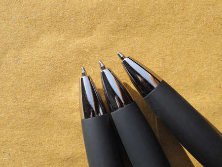 ballpoint pen on blank brown paper with copy space