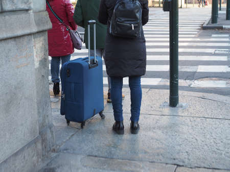 TURIN, ITALY - CIRCA DECEMBER 2019: Tourists with luggage in the city centreのeditorial素材
