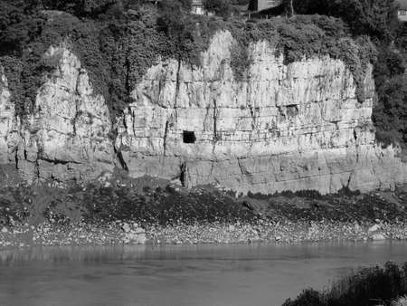 Gloucester Hole in the limestone cliffs of the River Wye in Chepstow, UK in black and white