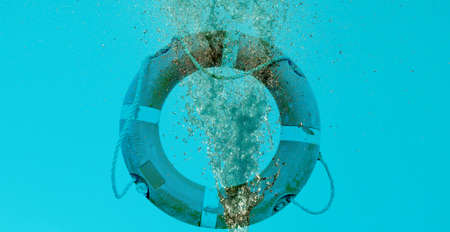 blue water flow splash and life buoy in the sea with copy spaceの写真素材