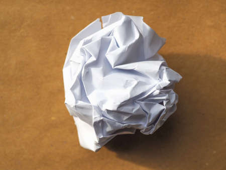 whie paper ball over brown paper backgroundの写真素材