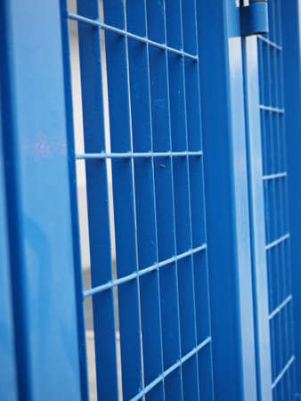 blue metal fence useful as a backgroundの写真素材
