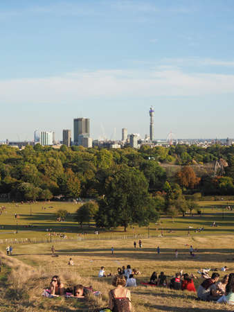 LONDON, UK - CIRCA SEPTEMBER 2019: People at Primrose Hill north of Regent's Park looking at London...
