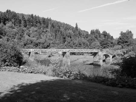 River Wye (Afon Gwy in Welsh) marks the border between England and Wales in Tintern, UK in black and...