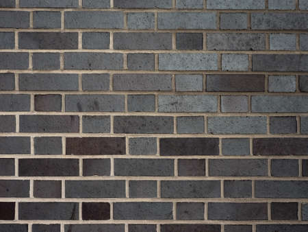 Black brick wall texture useful as a backgroundの写真素材