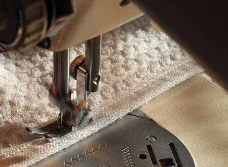 sewing machine to sew pieces of cloth together, motion blur showing needle movementの写真素材