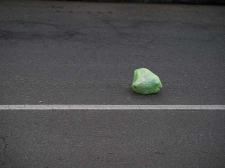 plastic bag in the middle of a road, symbol of pollution and the environment