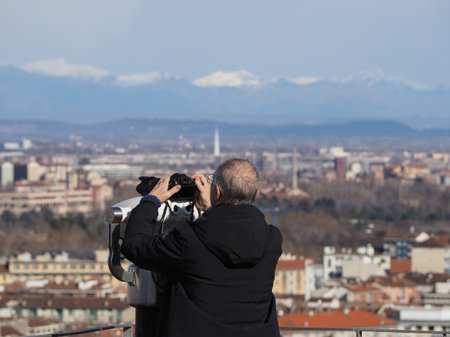 TURIN, ITALY - CIRCA FEBRUARY 2020: Photographer looking at aerial view of the cityのeditorial素材
