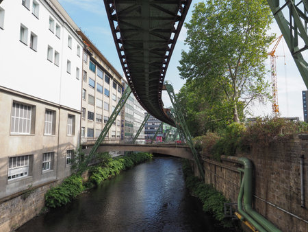 WUPPERTAL, GERMANY - CIRCA AUGUST 2019: Wuppertaler Schwebebahn (meaning Wuppertal Suspension Railway) above River Wupper is the oldest electric elevated railway with hanging cars in the worldのeditorial素材