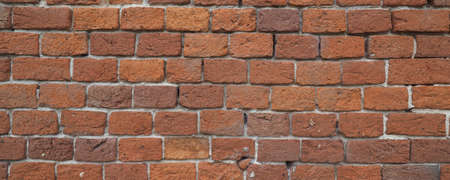 wide red brick wall useful as a backgroundの写真素材
