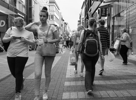 KOELN, GERMANY - CIRCA AUGUST 2019: People in Hohe Strasse (meaning High Street) shopping street in black and whiteのeditorial素材