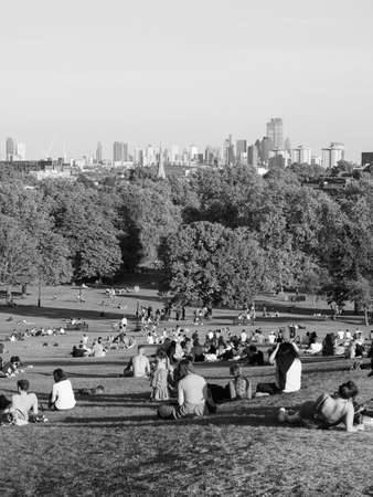 LONDON, UK - CIRCA SEPTEMBER 2019: People at Primrose Hill north of Regent's Park looking at London skyline at sunset in black and whiteのeditorial素材
