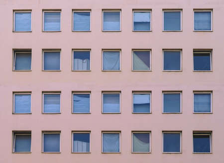 Modern pink facade with many square windows