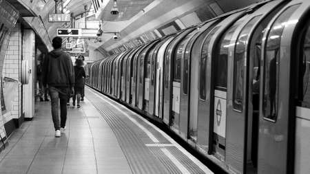 LONDON, UK - CIRCA SEPTEMBER 2019: Oxford Circus tube station platform in black and white
