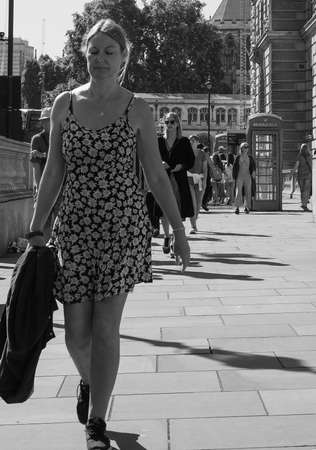 LONDON, UK - CIRCA SEPTEMBER 2019: People in the city centre in black and whiteのeditorial素材