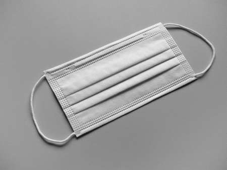 face mask used to protect from respiratory illnesses including  in black and whiteの写真素材